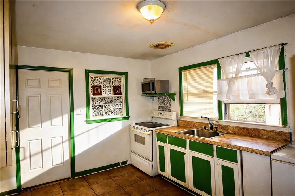 154 Privette Road Southwest Marietta, GA 30008 - Photo 13 of 28 a kitchen that has a lot of windows in it