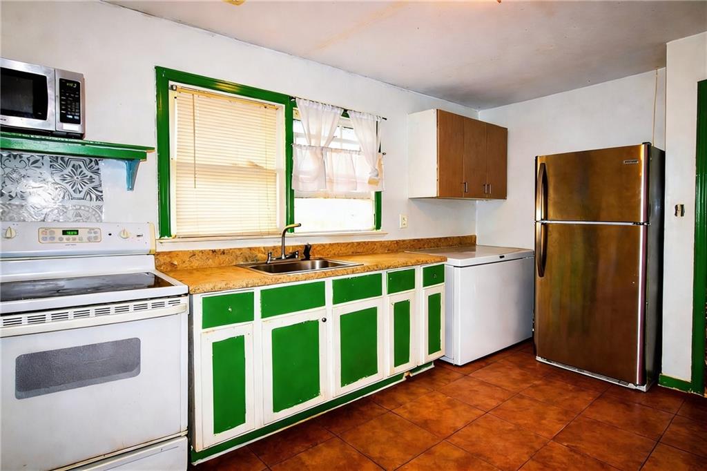 154 Privette Road Southwest Marietta, GA 30008 - Photo 14 of 28 a kitchen with a refrigerator and a sink