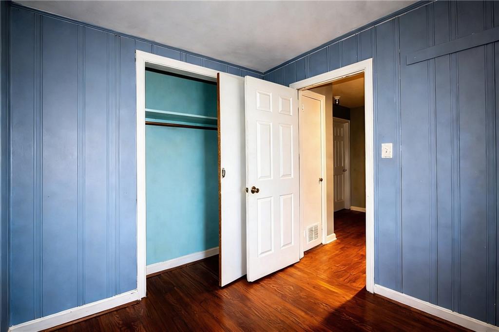 154 Privette Road Southwest Marietta, GA 30008 - Photo 18 of 28 a view of an empty room with wooden floor and a bathroom