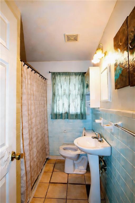 154 Privette Road Southwest Marietta, GA 30008 - Photo 21 of 28 a bathroom with a sink a toilet and a mirror