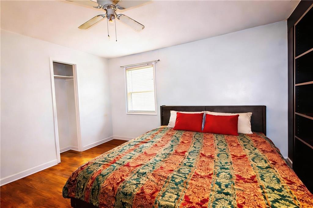 154 Privette Road Southwest Marietta, GA 30008 - Photo 23 of 28 a bedroom with a large bed and a chandelier