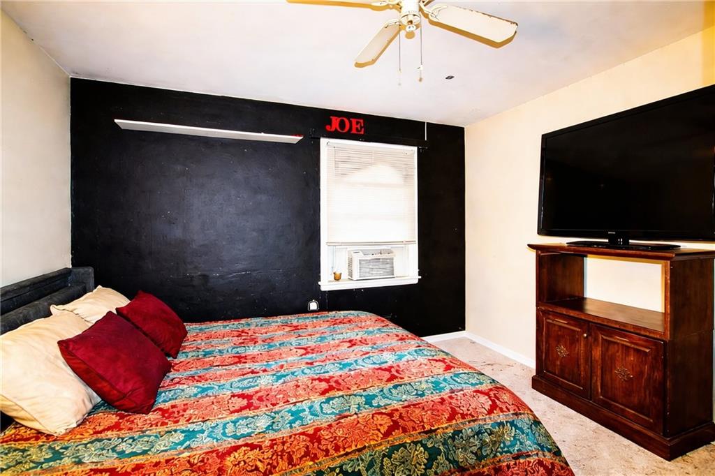 154 Privette Road Southwest Marietta, GA 30008 - Photo 24 of 28 a bedroom with a bed and a flat screen tv