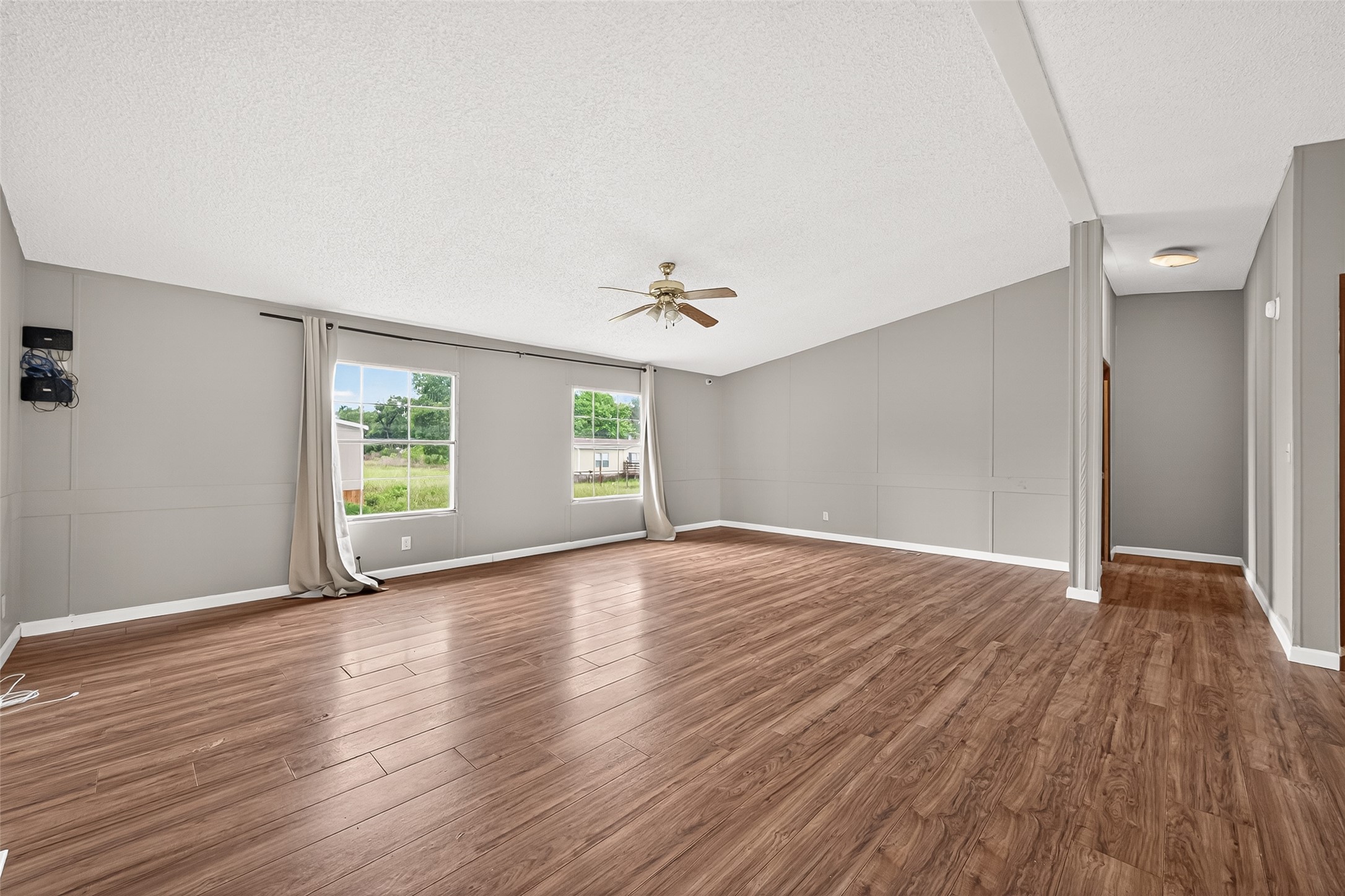 5982 Waukegan Road Conroe, TX 77306 - Photo 13 of 49 an empty room with wooden floor and windows