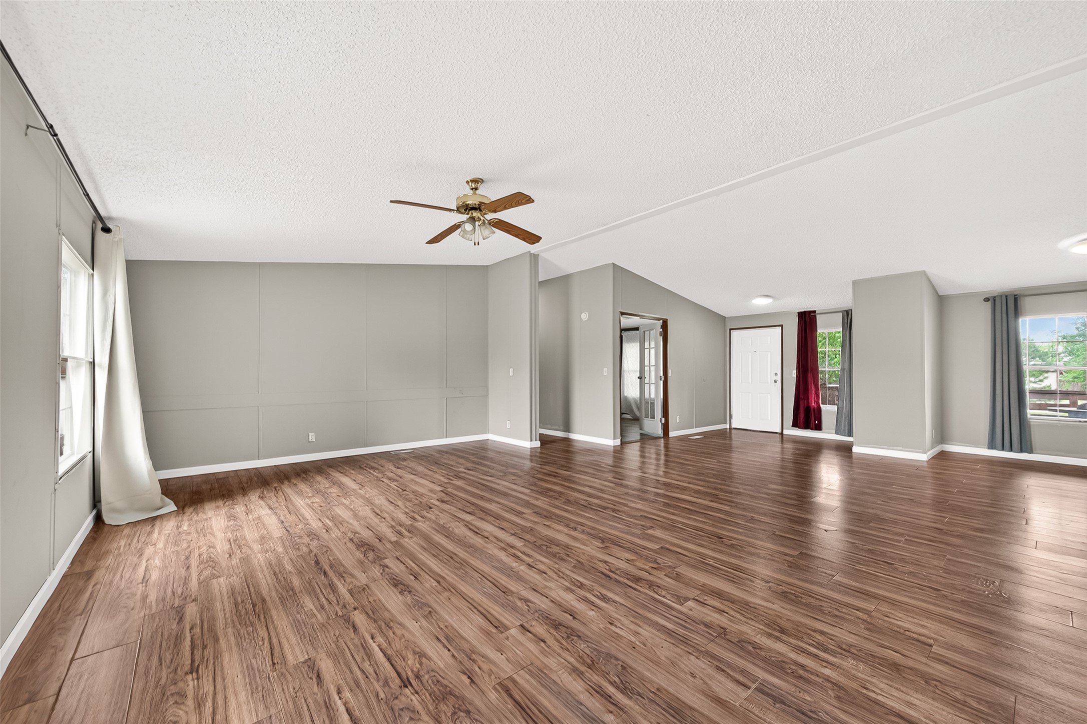 5982 Waukegan Road Conroe, TX 77306 - Photo 14 of 49 a view of an empty room with wooden floor and a window