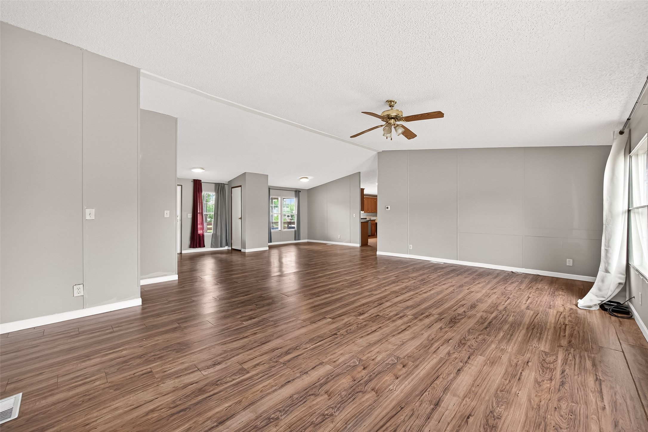 5982 Waukegan Road Conroe, TX 77306 - Photo 15 of 49 an empty room with wooden floor and a ceiling fan
