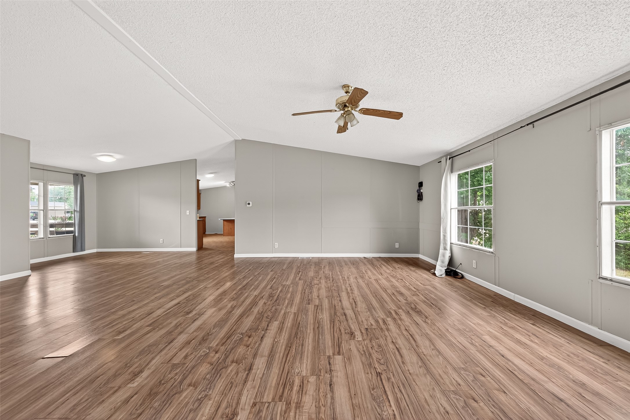 5982 Waukegan Road Conroe, TX 77306 - Photo 16 of 49 a view of empty room with wooden floor and fan