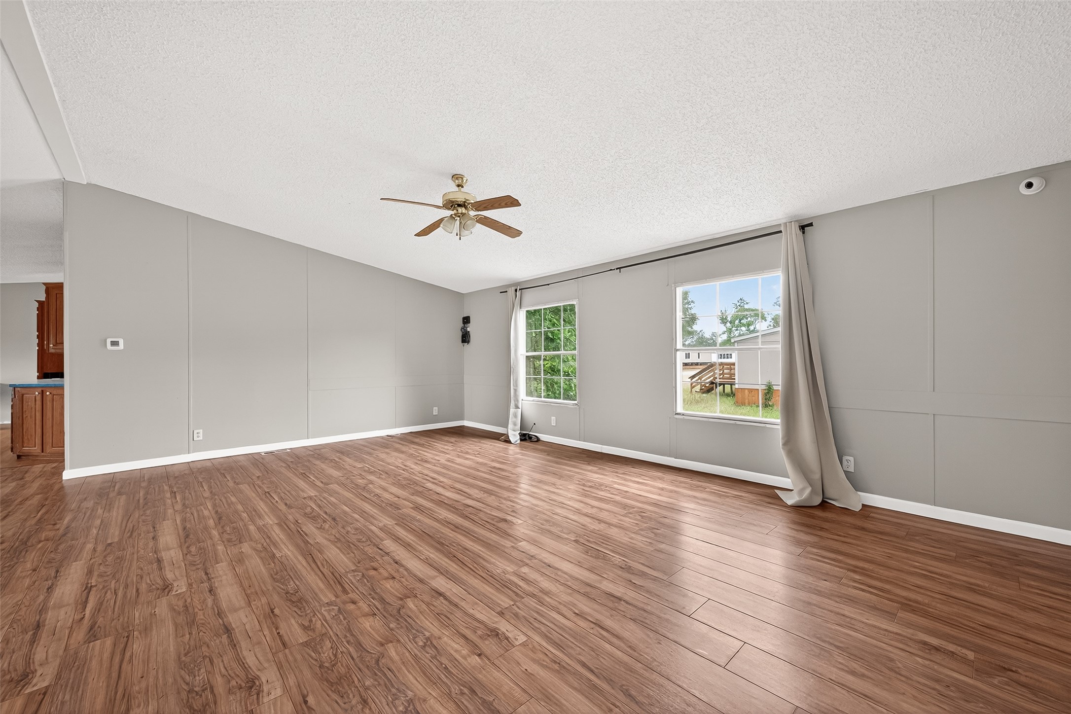 5982 Waukegan Road Conroe, TX 77306 - Photo 17 of 49 an empty room with wooden floor and window
