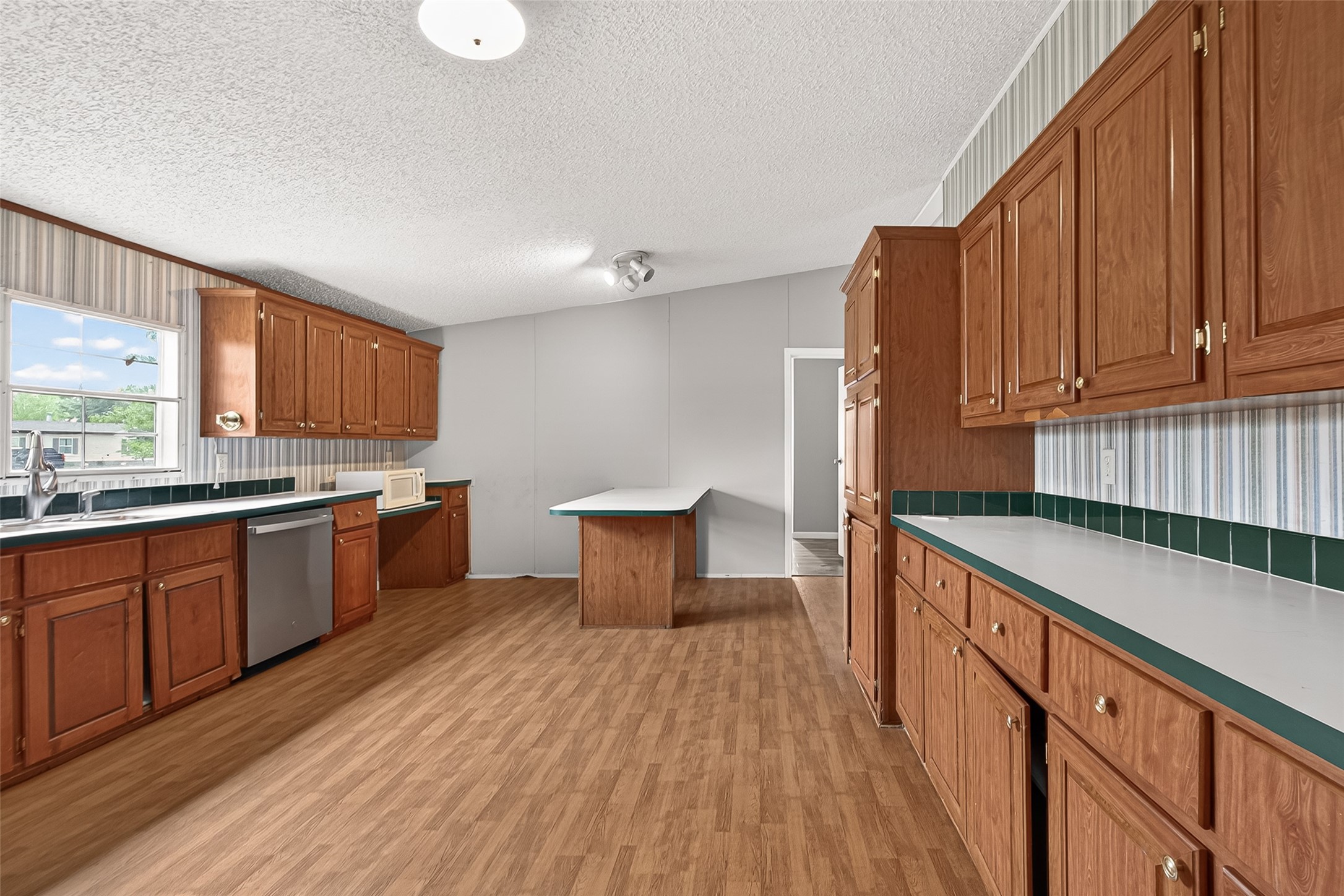 5982 Waukegan Road Conroe, TX 77306 - Photo 18 of 49 a kitchen with stainless steel appliances granite countertop a stove a sink dishwasher and a refrigerator with wooden cabinets