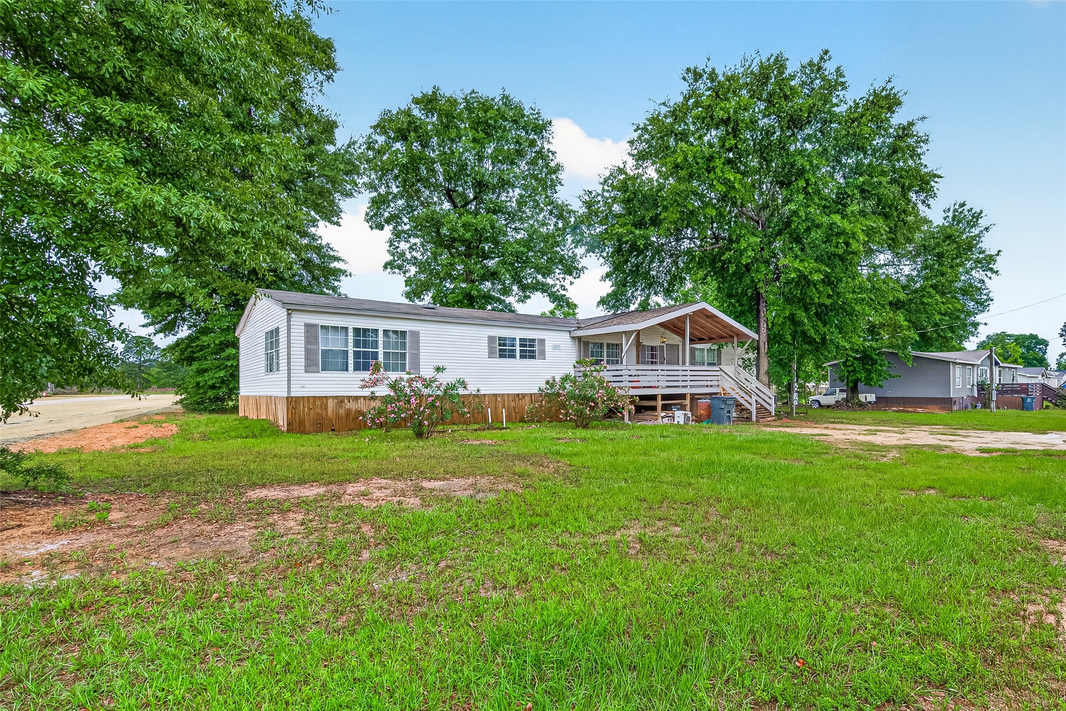 5982 Waukegan Road Conroe, TX 77306 - Photo 2 of 49 a front view of a house with a yard and trees