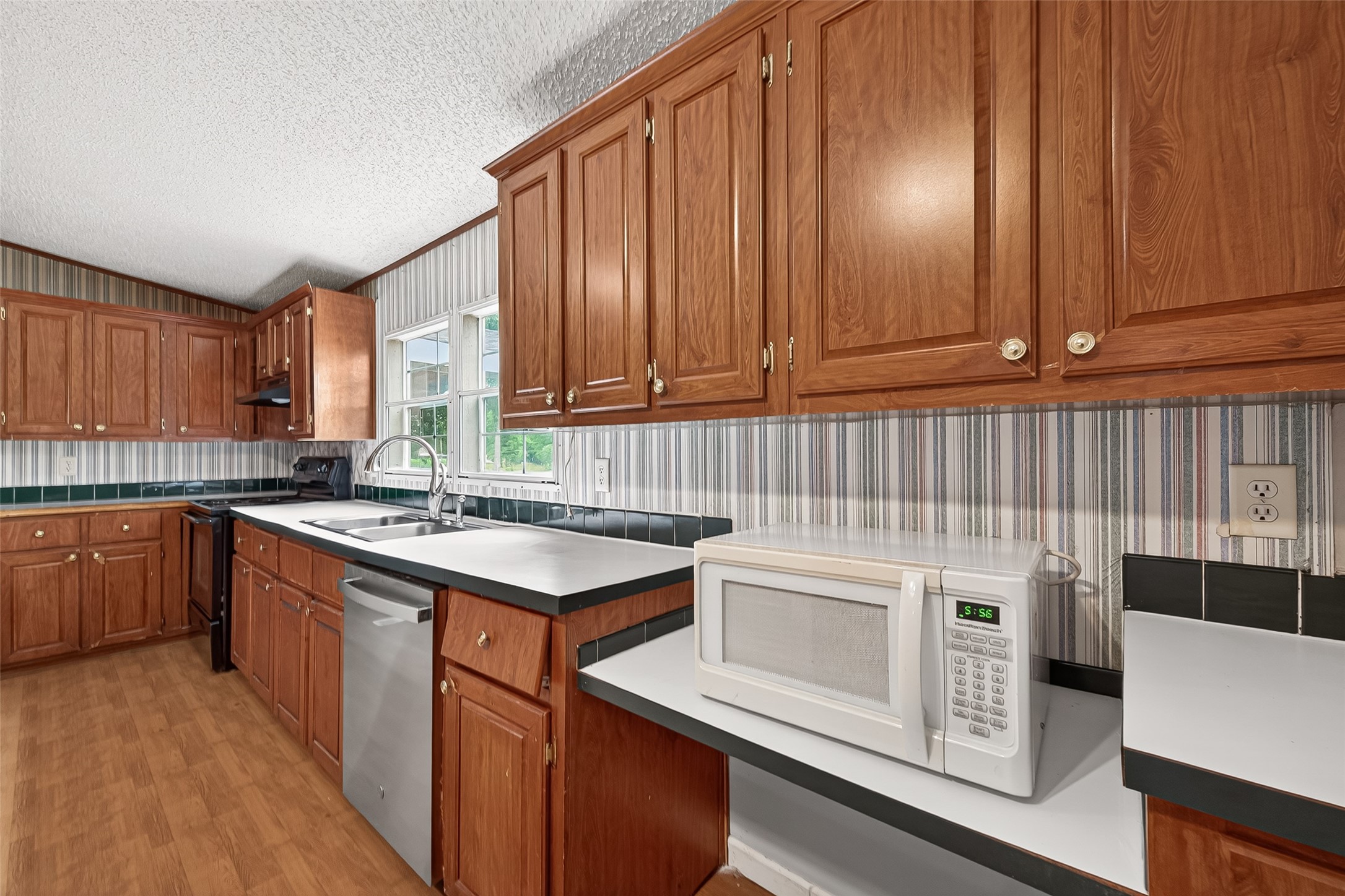 5982 Waukegan Road Conroe, TX 77306 - Photo 22 of 49 a kitchen with a sink stove and cabinets