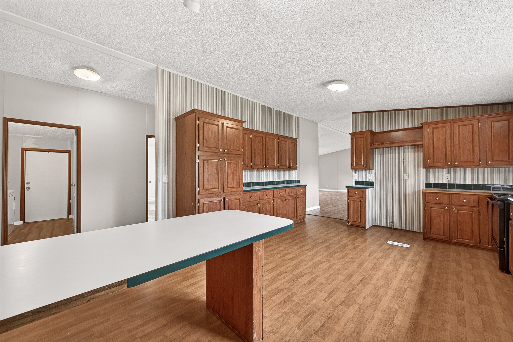 5982 Waukegan Road Conroe, TX 77306 - Photo 23 of 49 a kitchen with stainless steel appliances a refrigerator and wooden floor