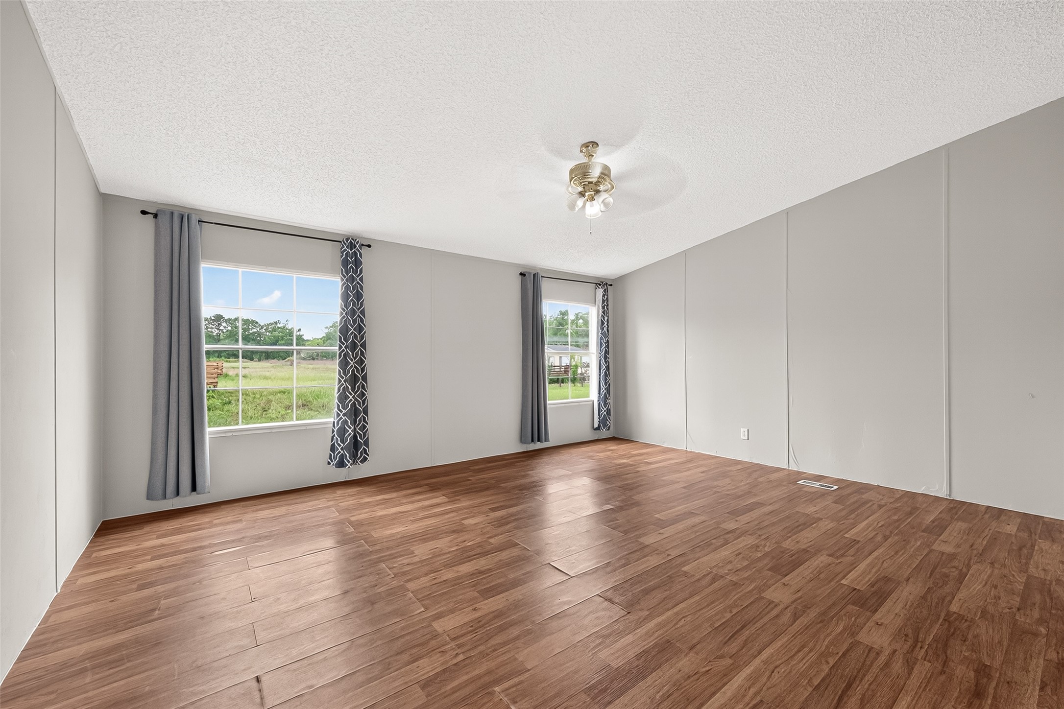5982 Waukegan Road Conroe, TX 77306 - Photo 25 of 49 a view of an empty room with a window and wooden floor