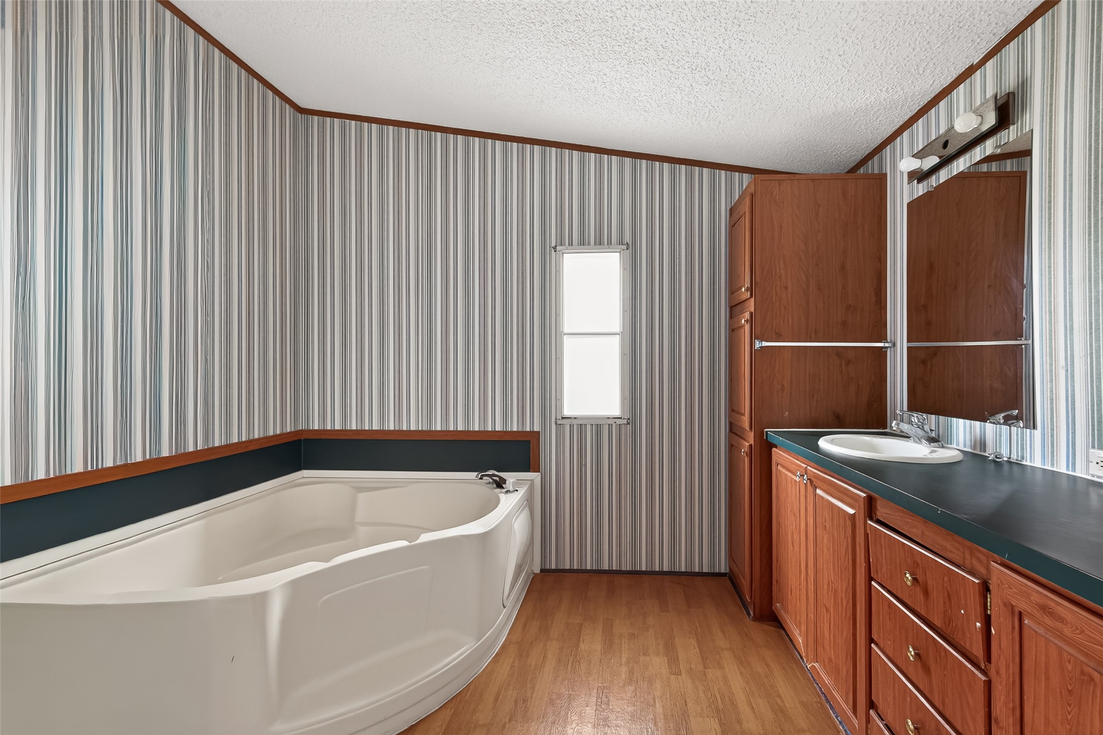 5982 Waukegan Road Conroe, TX 77306 - Photo 30 of 49 a bathroom with a bathtub and a sink