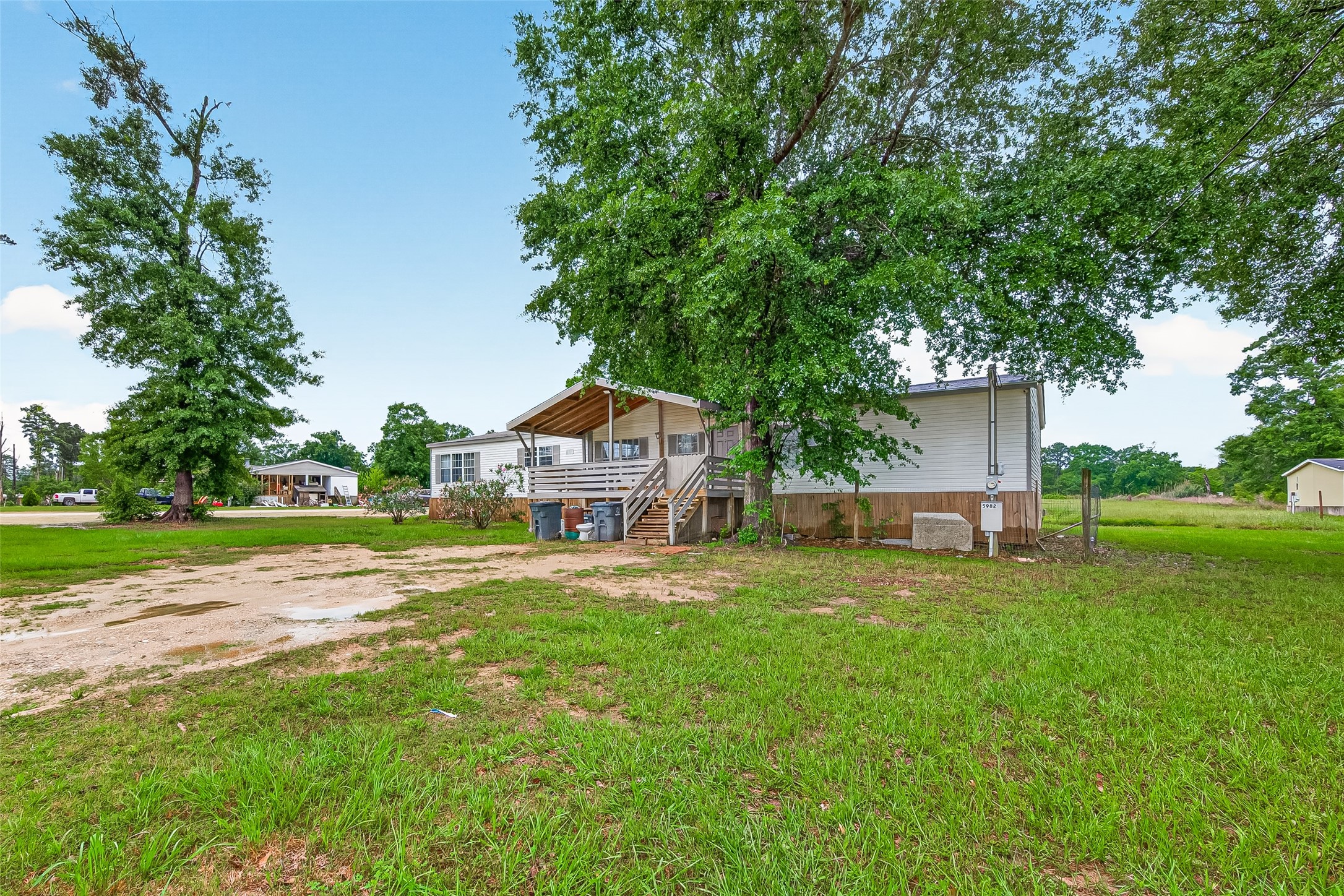 5982 Waukegan Road Conroe, TX 77306 - Photo 3 of 49 a view of a house with a big yard potted plants and large tree