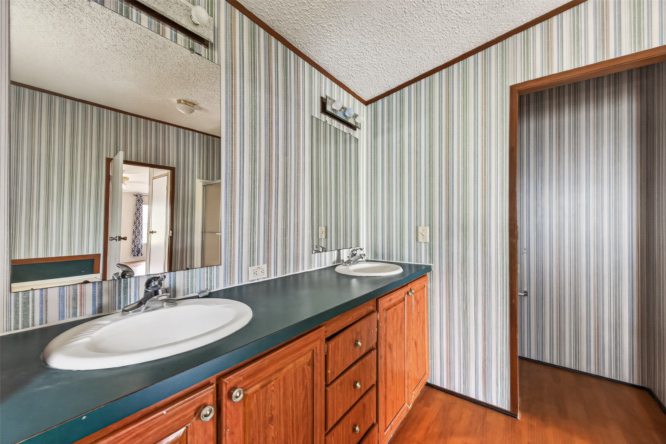 5982 Waukegan Road Conroe, TX 77306 - Photo 31 of 49 a bathroom with a granite countertop sink and a mirror