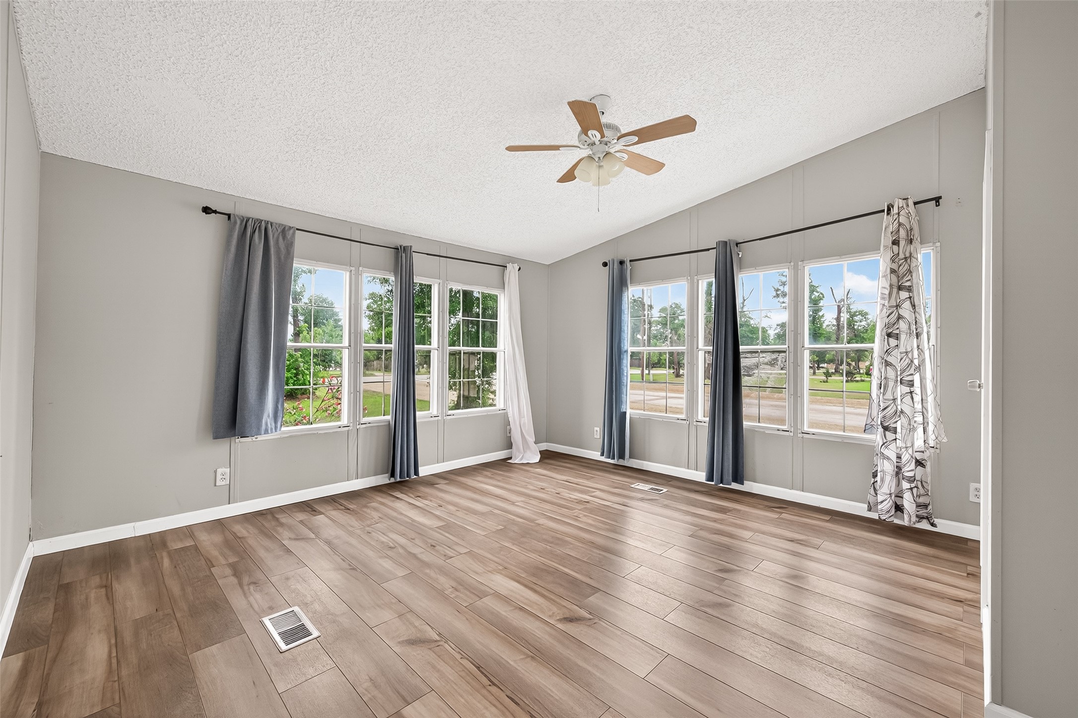 5982 Waukegan Road Conroe, TX 77306 - Photo 36 of 49 a view of an empty room with wooden floor and a window