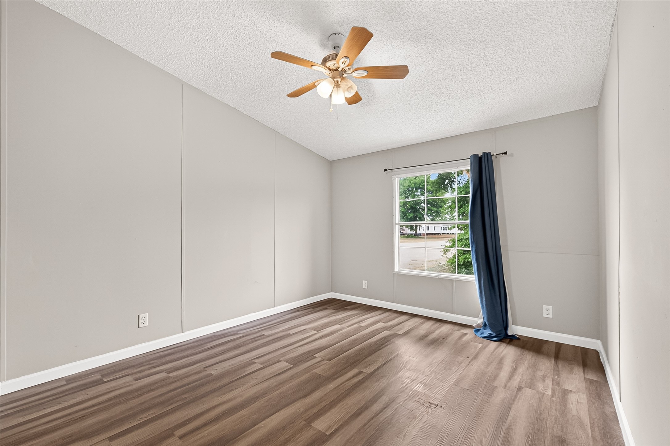 5982 Waukegan Road Conroe, TX 77306 - Photo 39 of 49 wooden floor in an empty room with a window