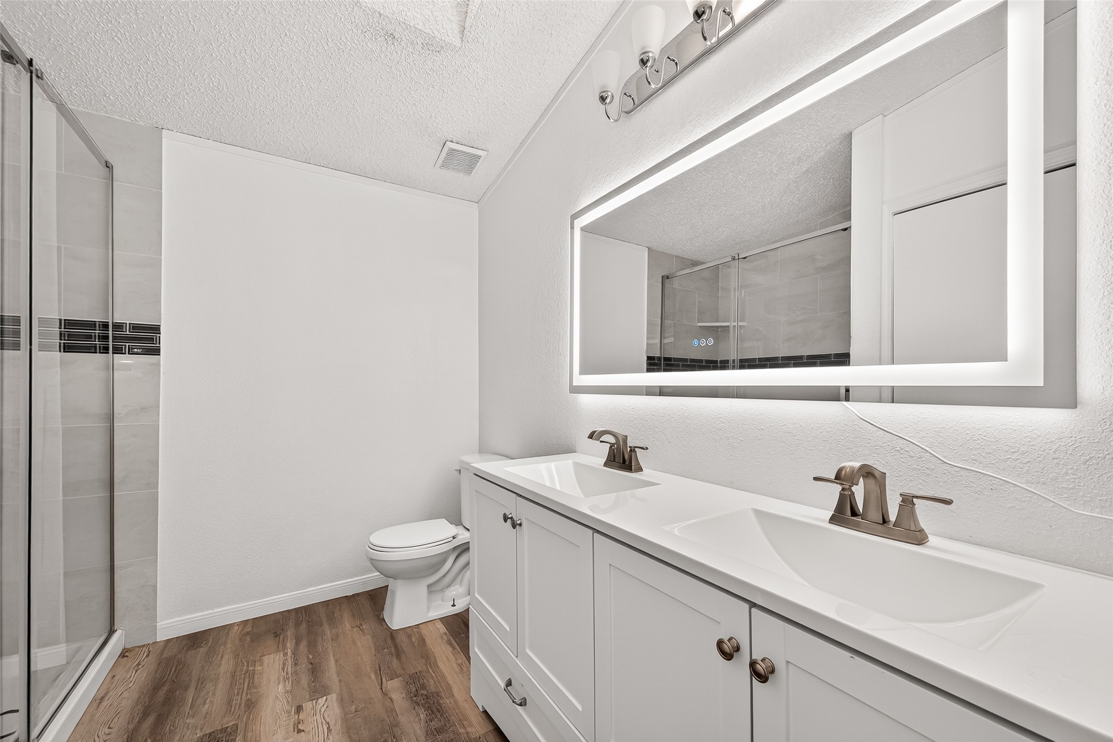 5982 Waukegan Road Conroe, TX 77306 - Photo 42 of 49 a bathroom with a sink a toilet and a mirror