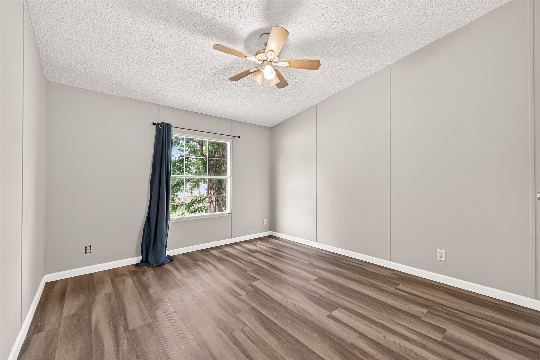 5982 Waukegan Road Conroe, TX 77306 - Photo 44 of 49 wooden floor in an empty room with a window