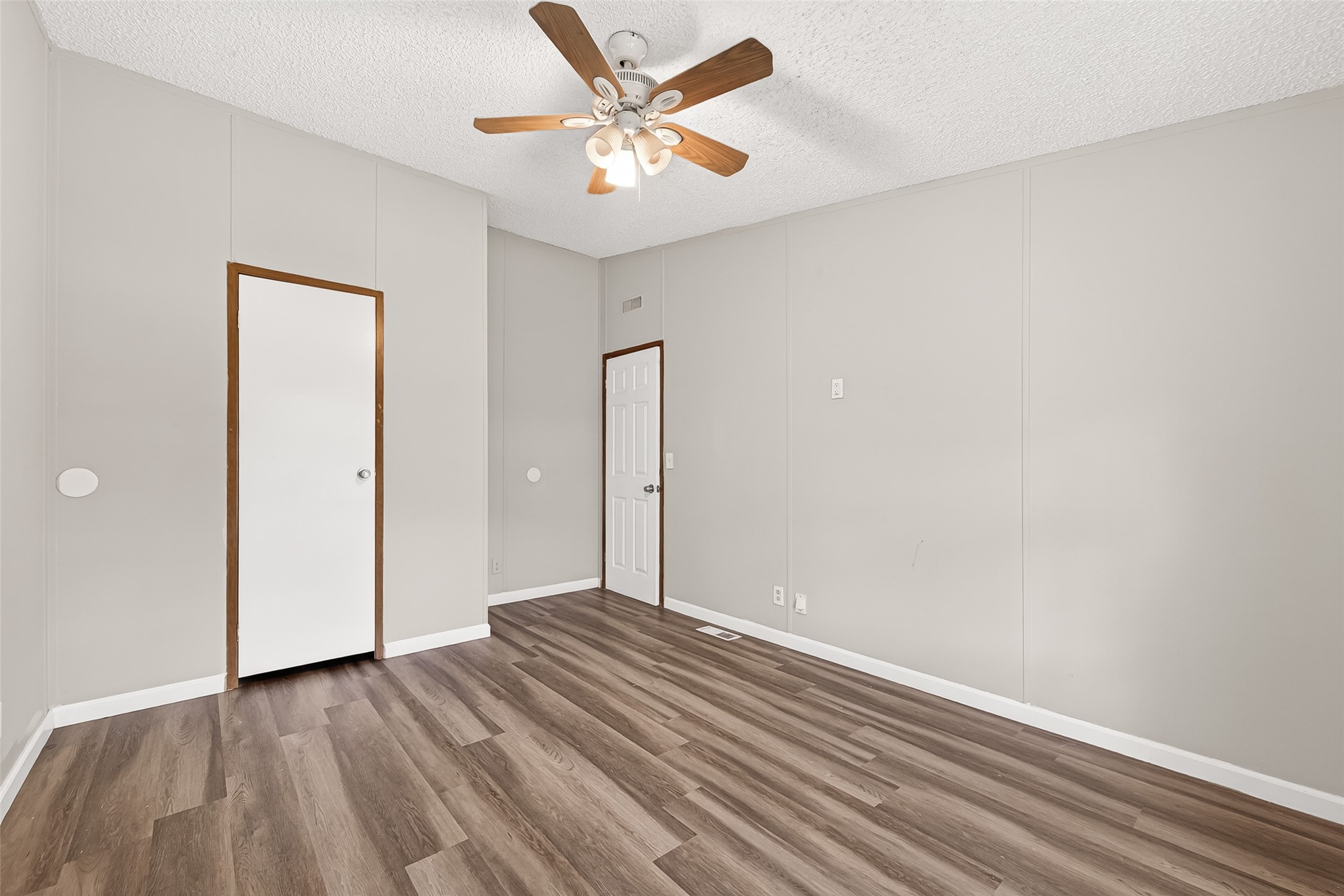 5982 Waukegan Road Conroe, TX 77306 - Photo 45 of 49 wooden floor in an empty room with a window