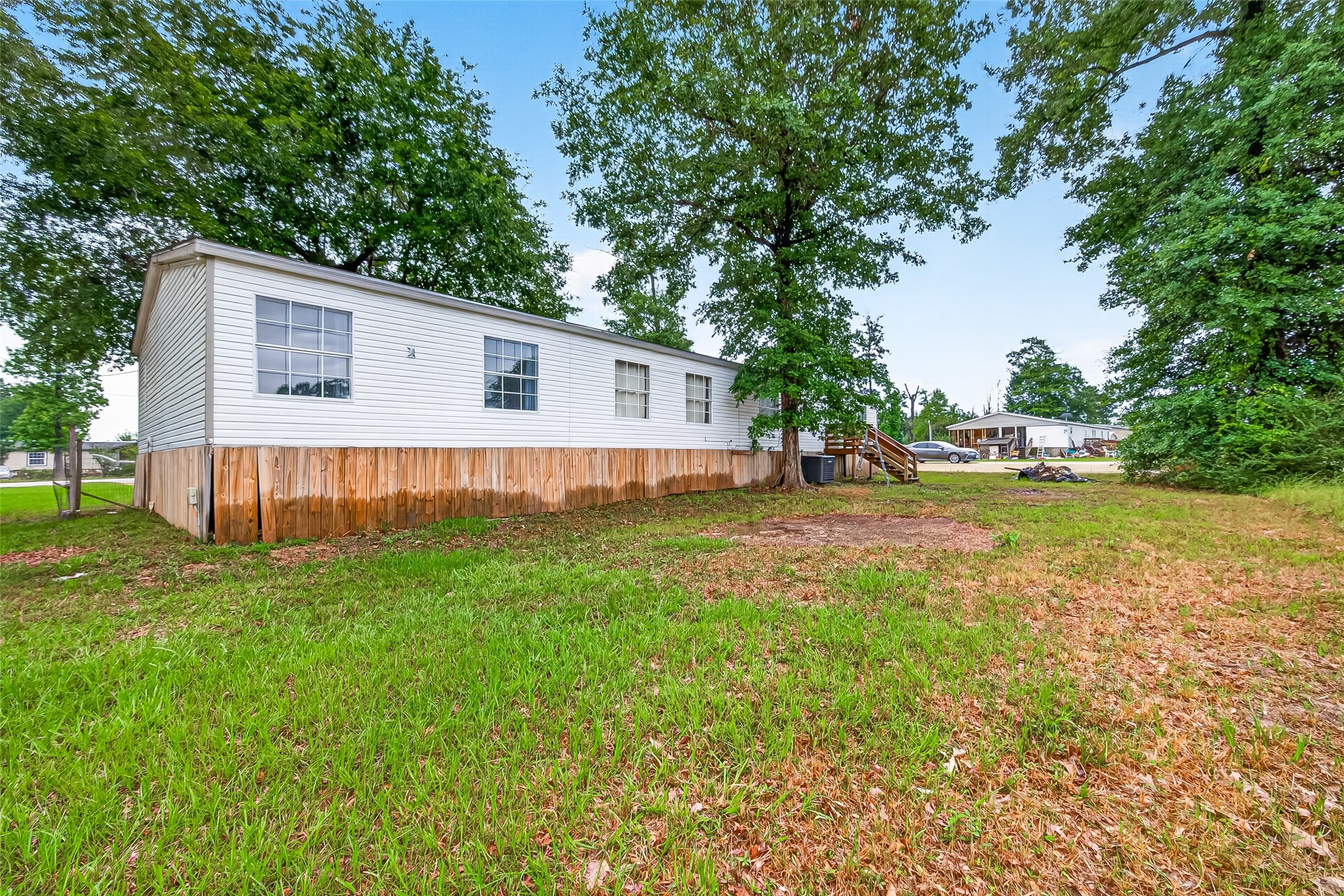 5982 Waukegan Road Conroe, TX 77306 - Photo 47 of 49 a view of a house with a yard and sitting area
