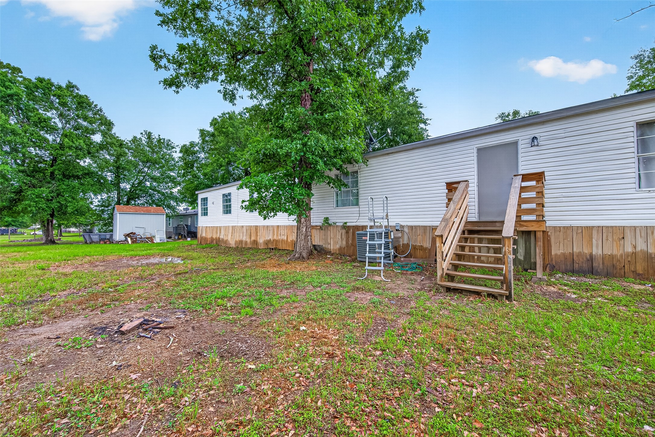 5982 Waukegan Road Conroe, TX 77306 - Photo 48 of 49 a view of a house with backyard and a tree