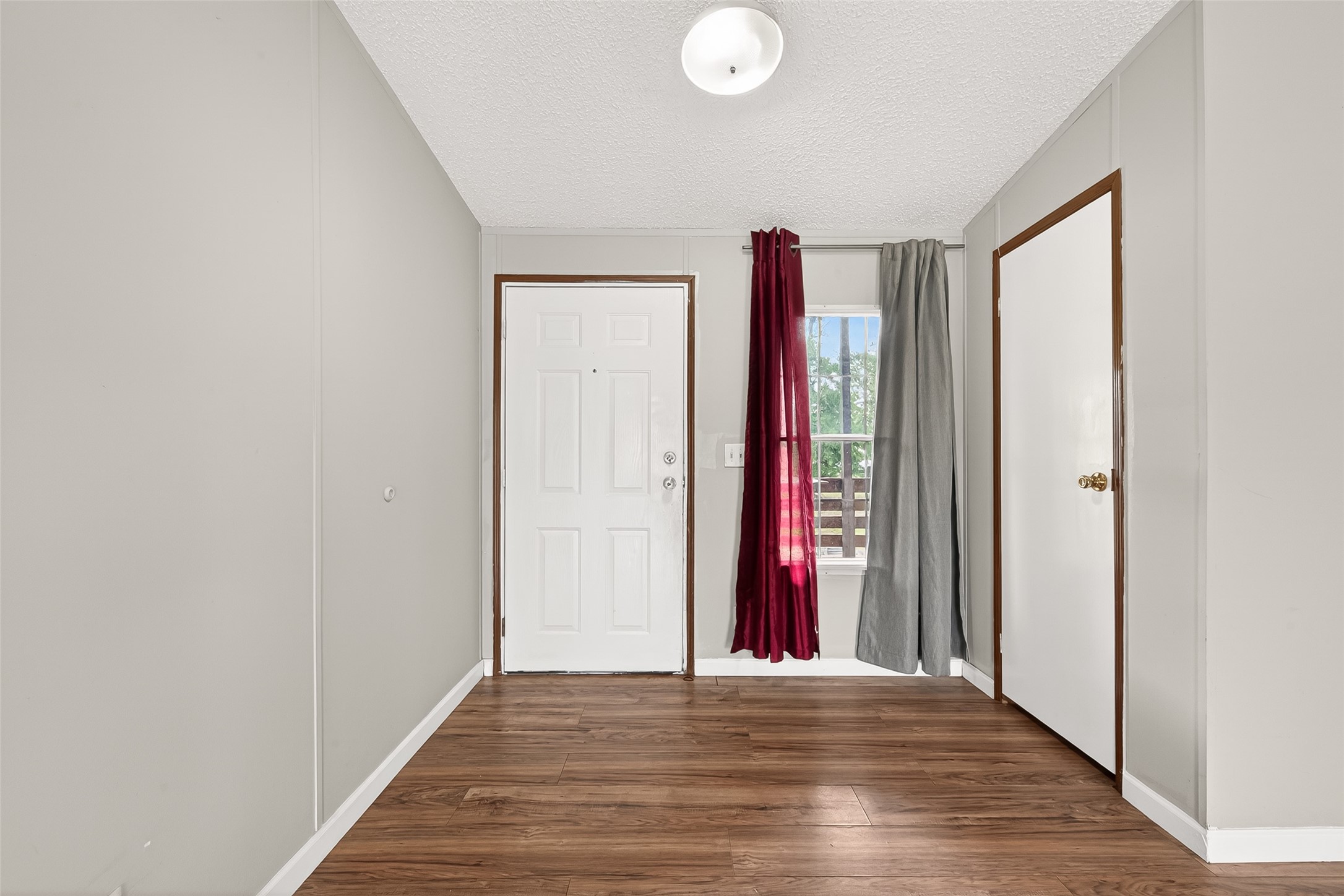 5982 Waukegan Road Conroe, TX 77306 - Photo 8 of 49 a view of a hallway with wooden floor and closet