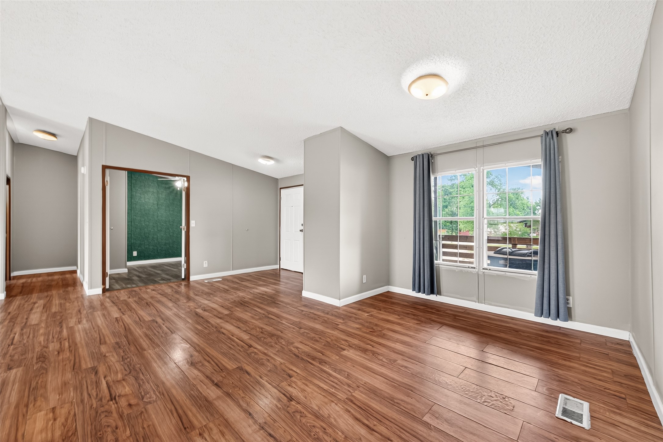 5982 Waukegan Road Conroe, TX 77306 - Photo 10 of 49 a view of an empty room with wooden floor and a window