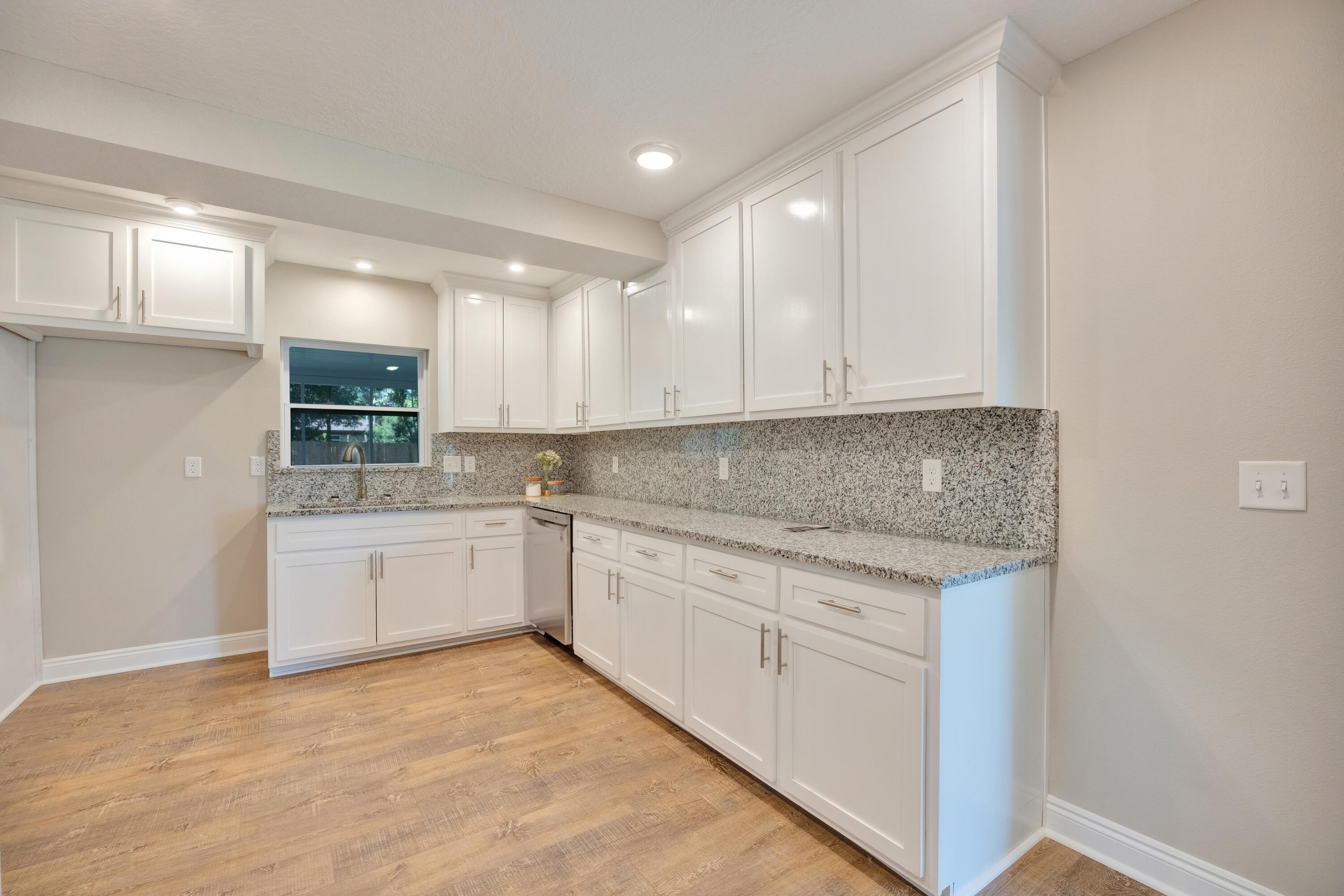 147 Gillis Drive Crestview, FL 32536 - Photo 19 of 62 a kitchen with granite countertop white cabinets and white appliances