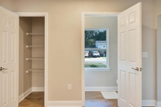 a white toilet sitting next to a window
