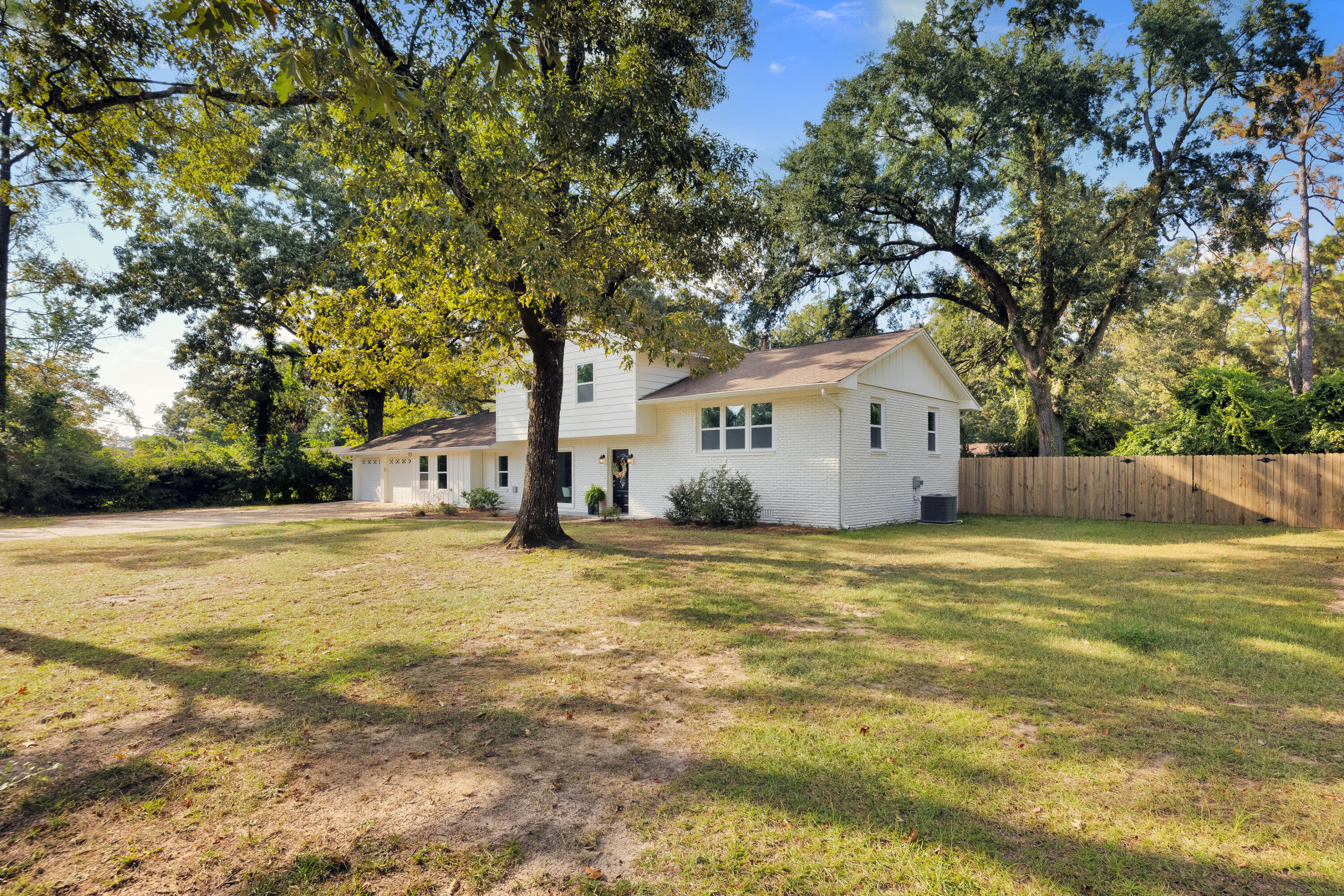 147 Gillis Drive Crestview, FL 32536 - Photo 2 of 62 a bathroom with a sink and large trees