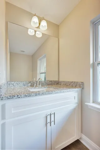 a living room with furniture a ceiling fan and a window