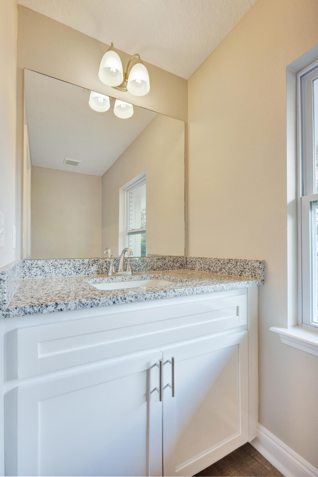 147 Gillis Drive Crestview, FL 32536 - Photo 21 of 62 a bathroom with a granite countertop sink and a mirror