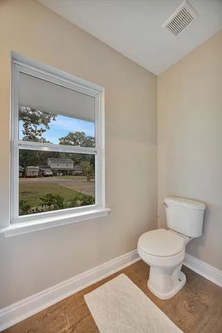 a living room with furniture and a ceiling fan