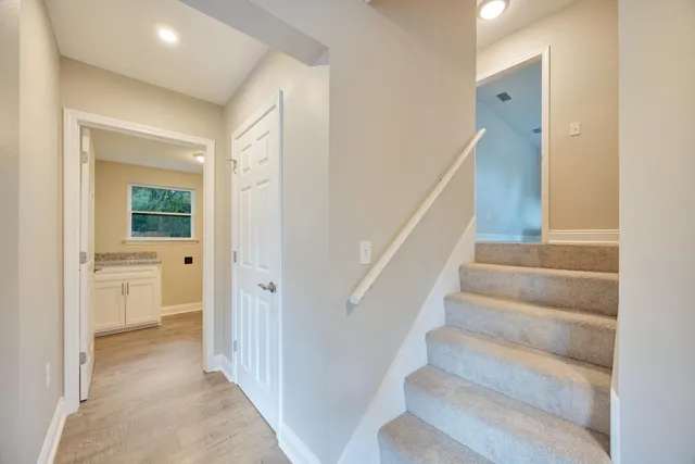 a bathroom with a granite countertop sink a mirror and a shower