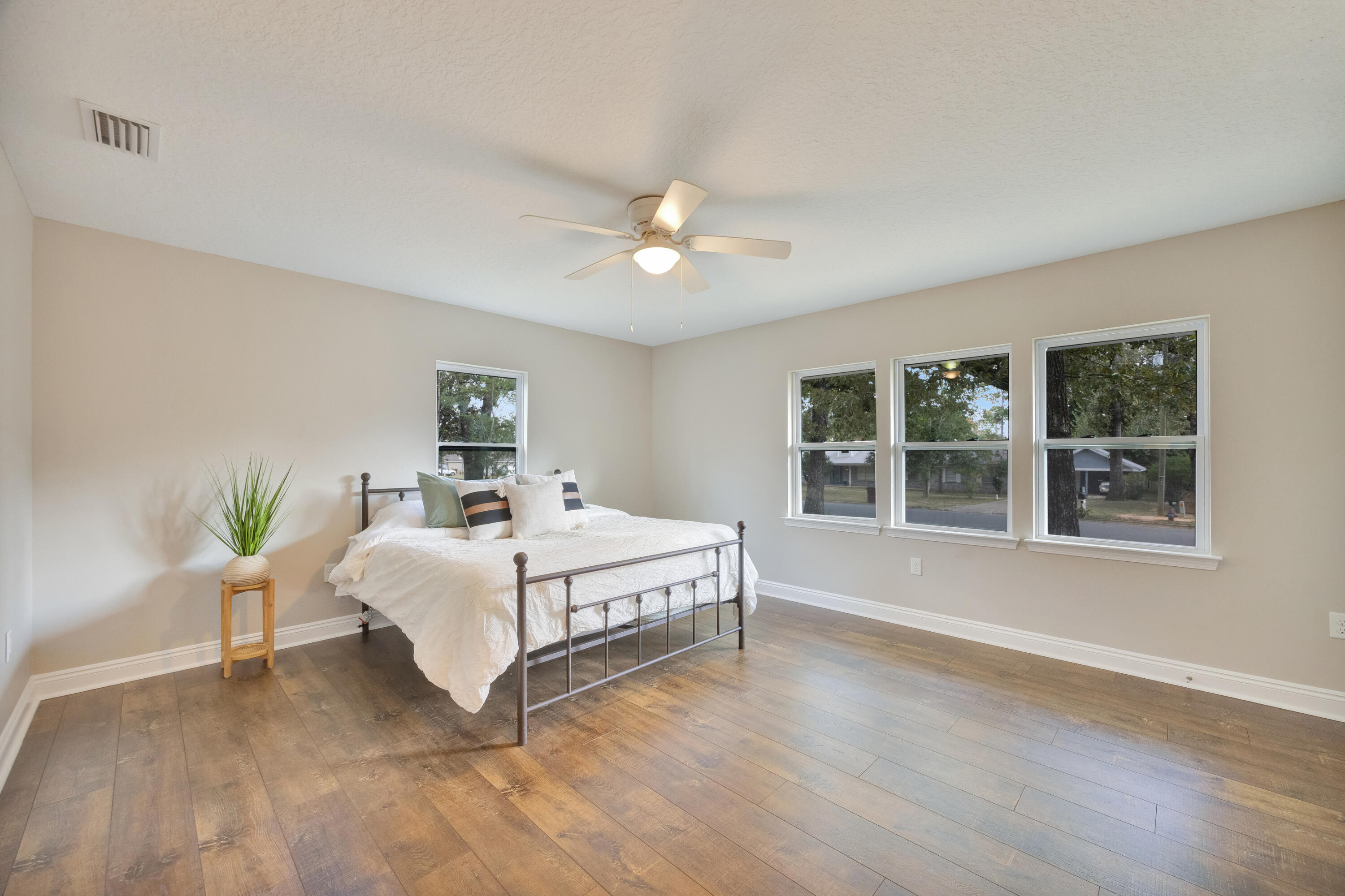 147 Gillis Drive Crestview, FL 32536 - Photo 30 of 62 a white bed sitting in a bedroom next to a window