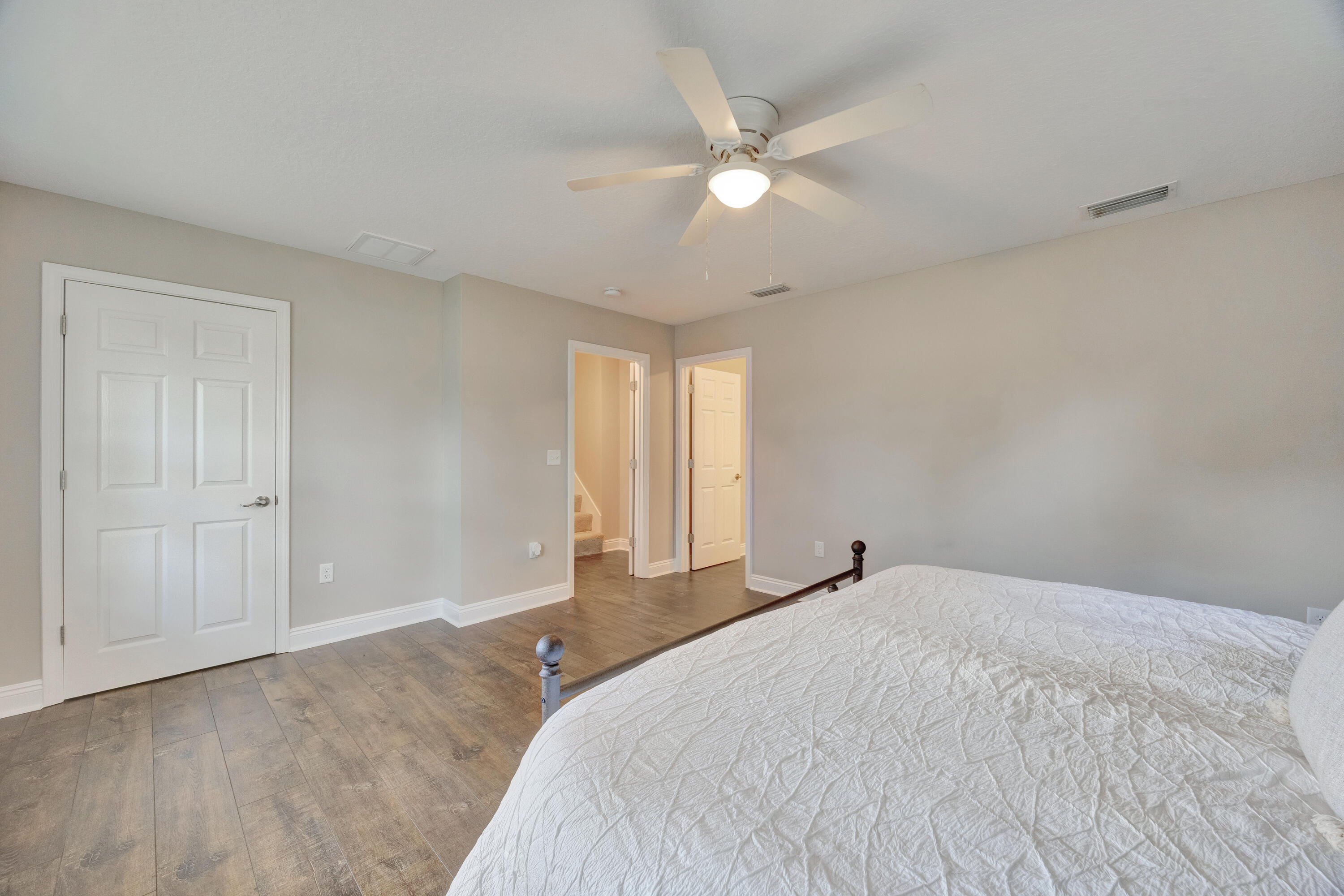 147 Gillis Drive Crestview, FL 32536 - Photo 31 of 62 a bedroom with a large bed and a chandelier