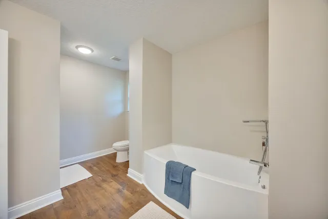a view of an empty room with a window and a ceiling fan