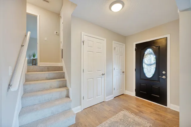 a view of an entryway with wooden floor and door
