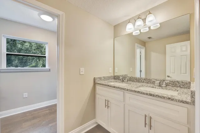 a front view of house with yard and trees