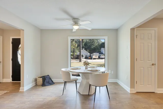 a dining room with furniture and wooden floor