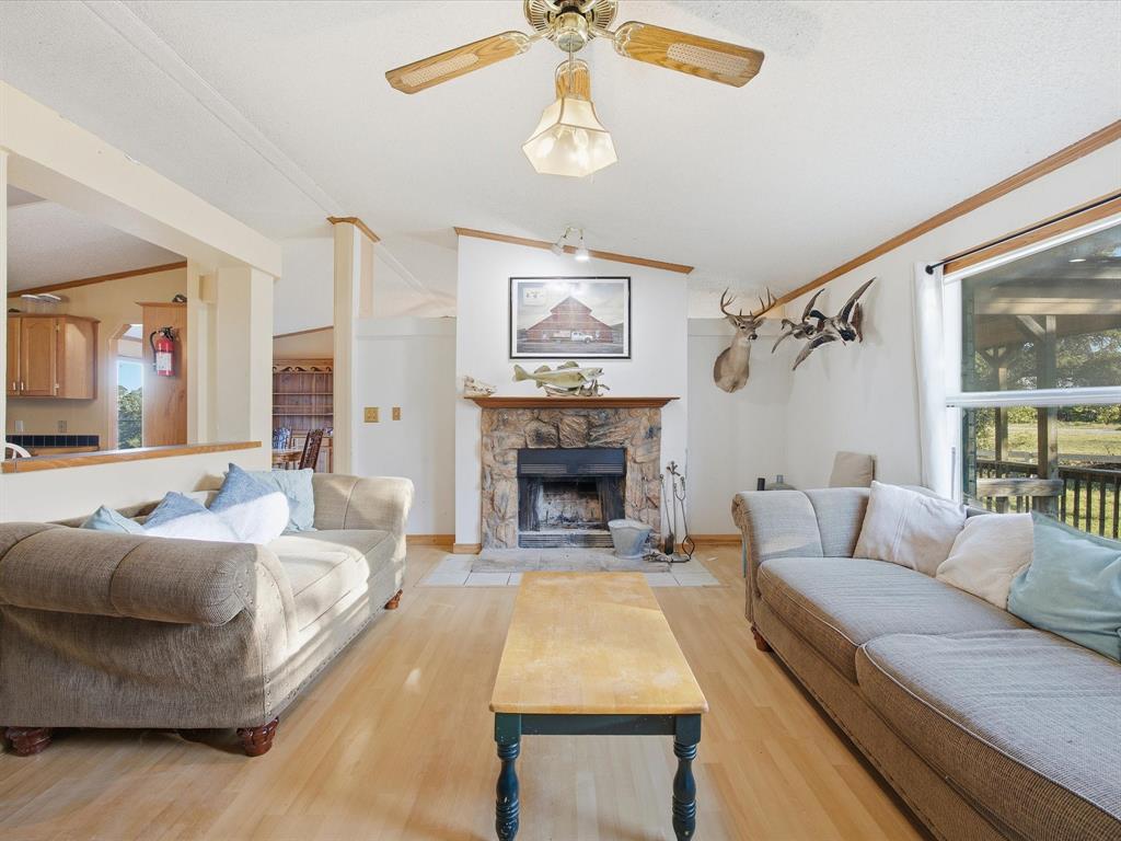381 West McCool Road Nocona, TX 76255 - Photo 16 of 39 a living room with furniture and a fireplace