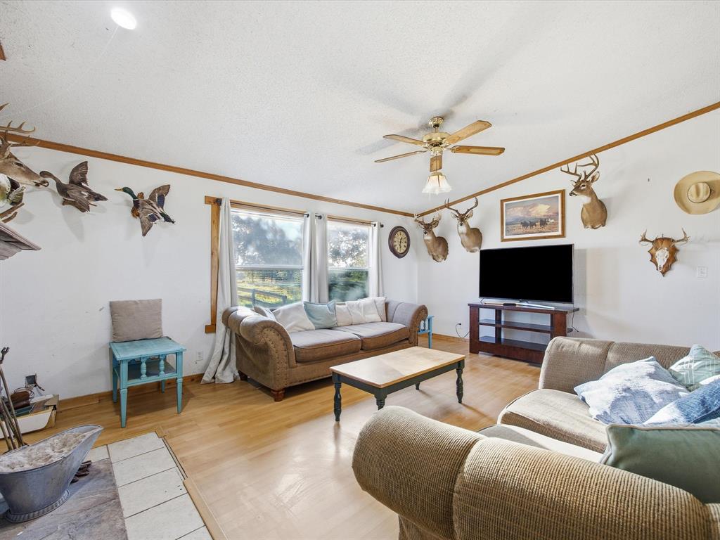 381 West McCool Road Nocona, TX 76255 - Photo 19 of 39 a living room with furniture a flat screen tv and a window
