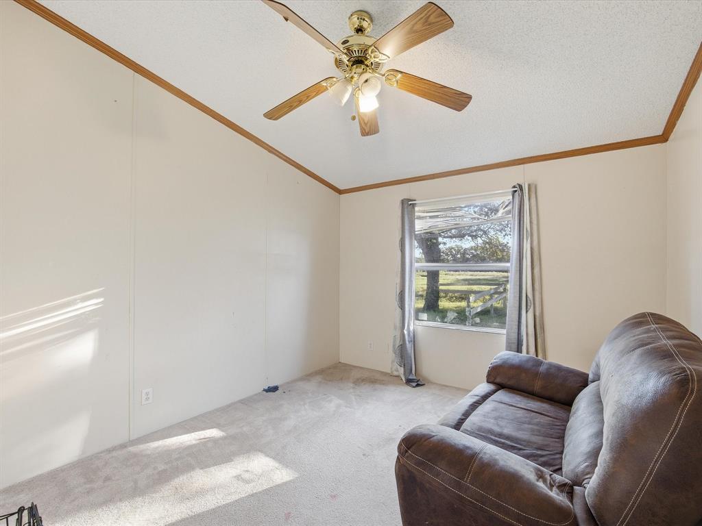 381 West McCool Road Nocona, TX 76255 - Photo 22 of 39 a living room with furniture and a window