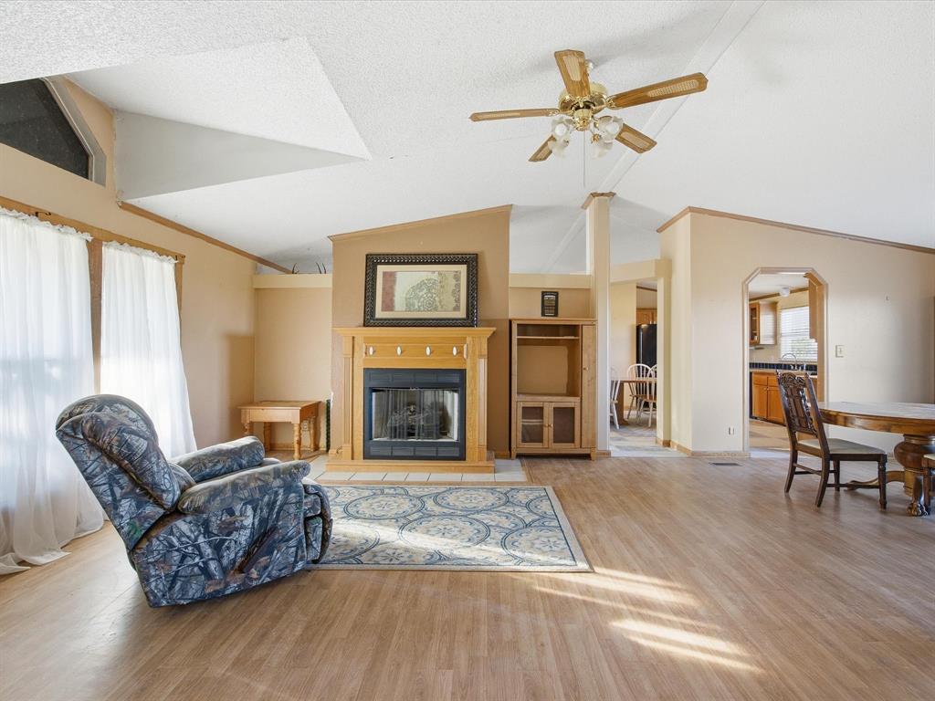 381 West McCool Road Nocona, TX 76255 - Photo 5 of 39 a living room with furniture and a fireplace