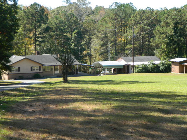 426 Huckabee Road Gray, GA 31032 - Photo 1 of 40 a view of a house with a big yard and large trees