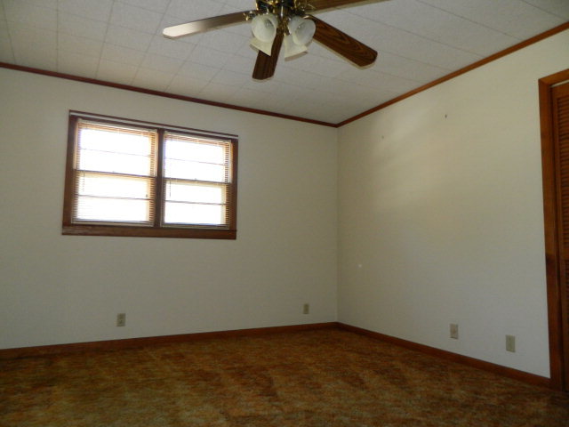 426 Huckabee Road Gray, GA 31032 - Photo 26 of 40 an empty room with a window and a ceiling fan