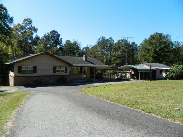 426 Huckabee Road Gray, GA 31032 - Photo 4 of 40 a front view of house with yard and trees in the background