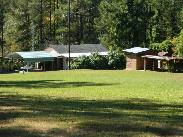 426 Huckabee Road Gray, GA 31032 - Photo 39 of 40 a view of a swimming pool with lawn chairs under an umbrella