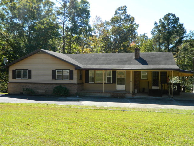 426 Huckabee Road Gray, GA 31032 - Photo 5 of 40 a front view of house with yard and trees in the background
